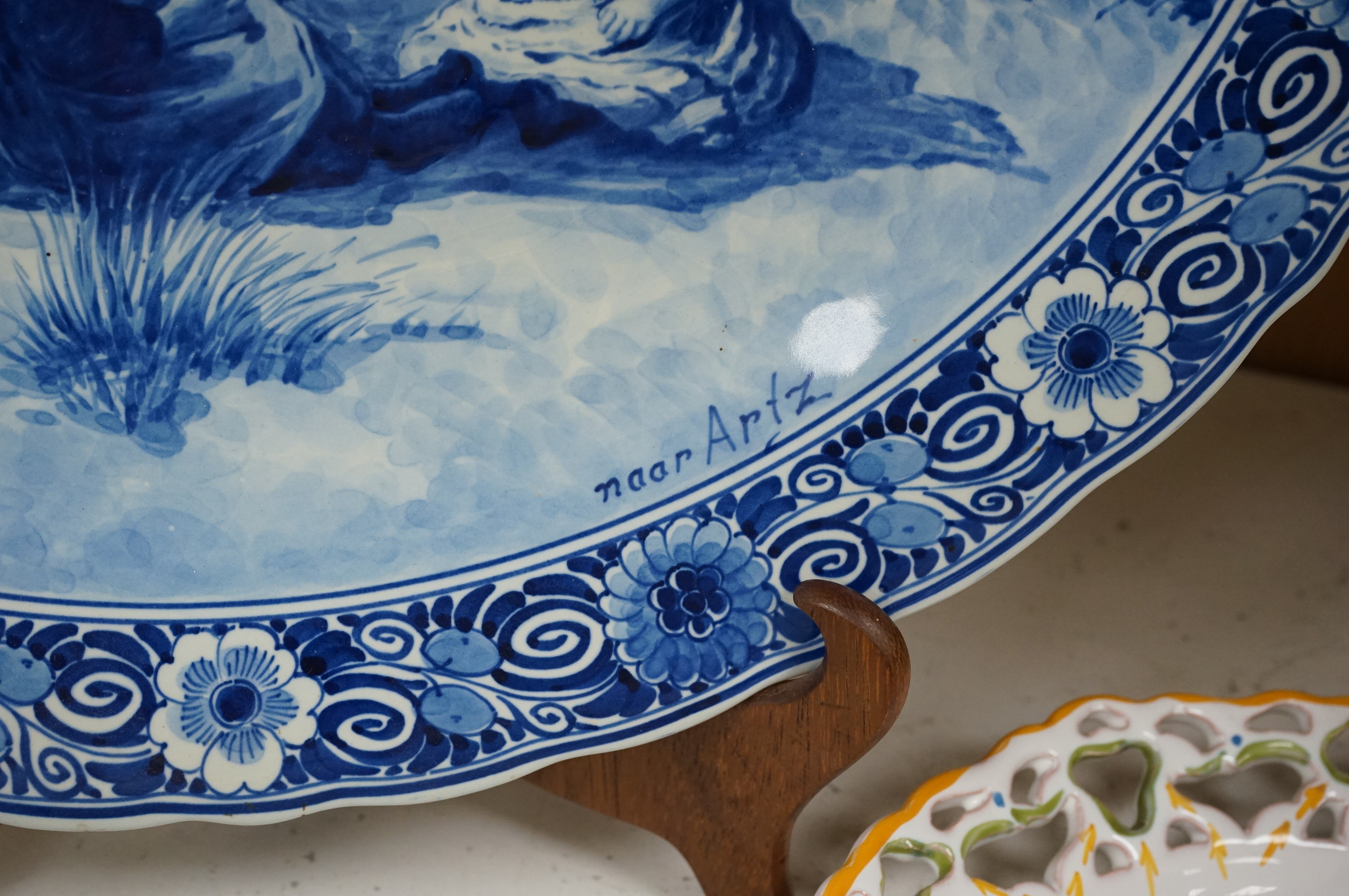 A Delft charger after Artz, together with other faience and majolica dishes, largest 41cm diameter (6)